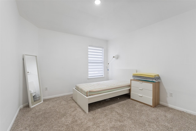 unfurnished bedroom featuring light carpet