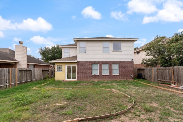 back of house with a lawn