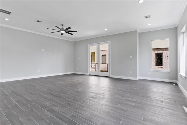 unfurnished living room with french doors, dark hardwood / wood-style flooring, ornamental molding, ceiling fan, and a fireplace