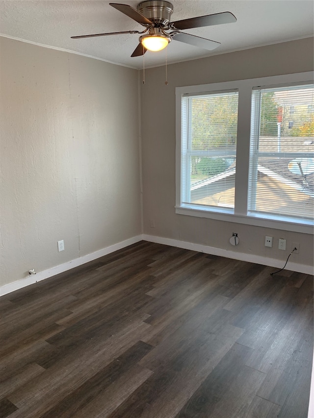 empty room featuring ceiling fan and dark hardwood / wood-style flooring