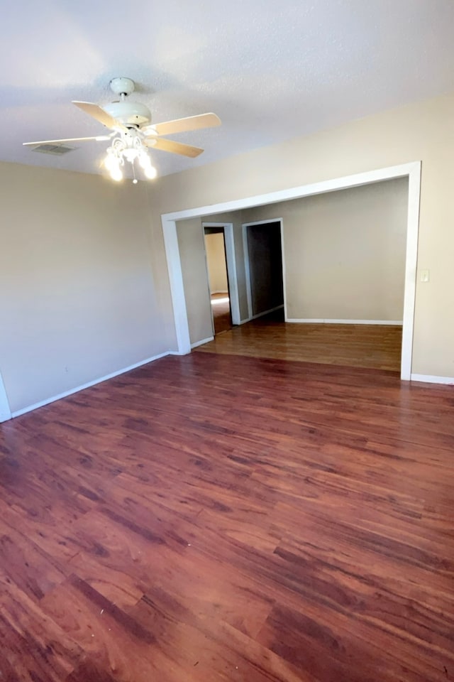 interior space with dark hardwood / wood-style floors and ceiling fan