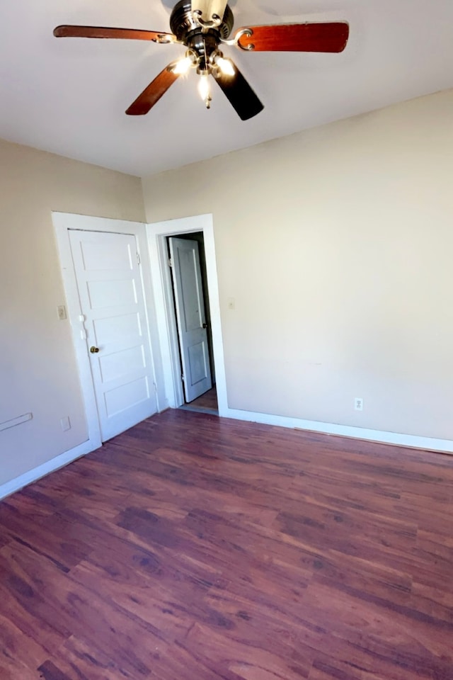 spare room with ceiling fan and dark hardwood / wood-style flooring