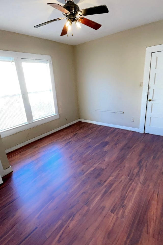 unfurnished room featuring ceiling fan and dark hardwood / wood-style floors