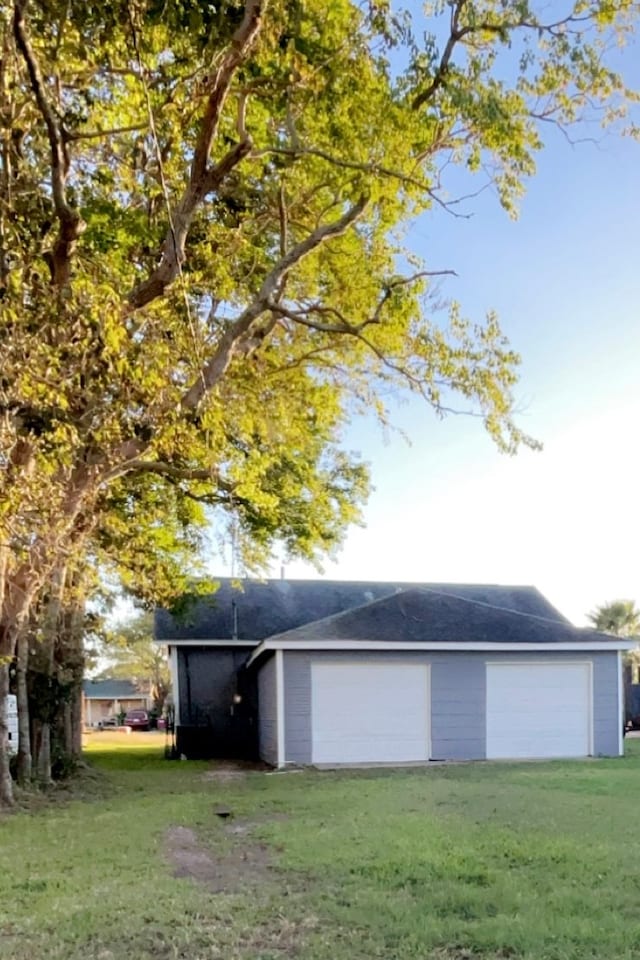 garage featuring a lawn