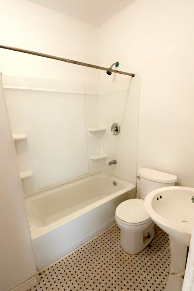 bathroom featuring toilet and shower / bath combination