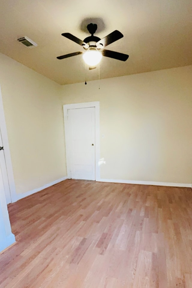 unfurnished room featuring ceiling fan and light wood-type flooring