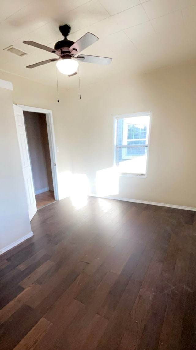 spare room featuring ceiling fan and dark hardwood / wood-style flooring