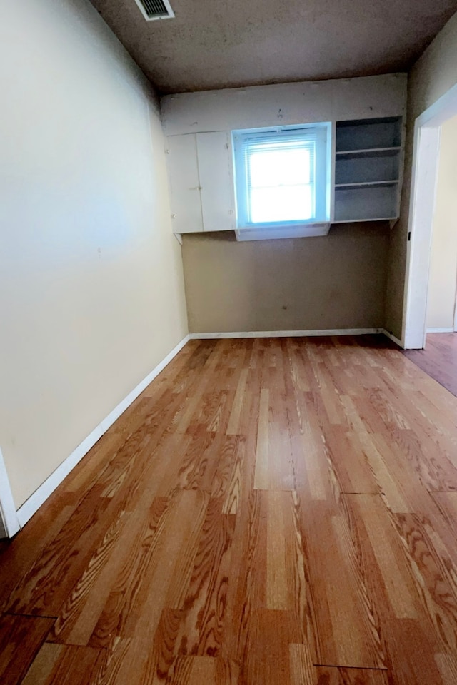 unfurnished room with light wood-type flooring