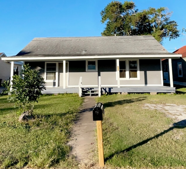 farmhouse inspired home with covered porch and a front yard