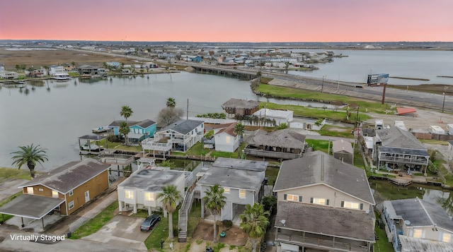 aerial view at dusk with a water view