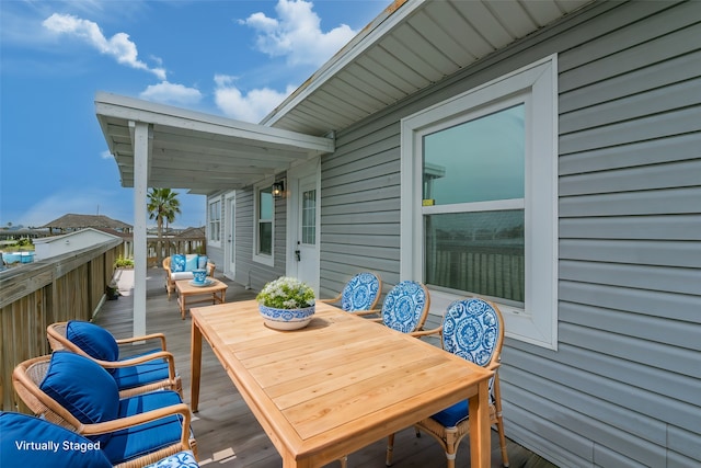 wooden terrace with an outdoor living space