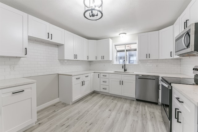 kitchen featuring white cabinetry, sink, and stainless steel appliances