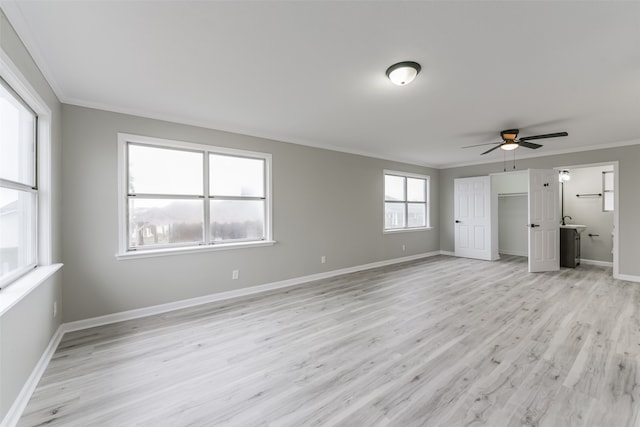 unfurnished bedroom with ceiling fan, light wood-type flooring, and crown molding