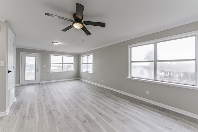 spare room with ceiling fan, light wood-type flooring, and ornamental molding