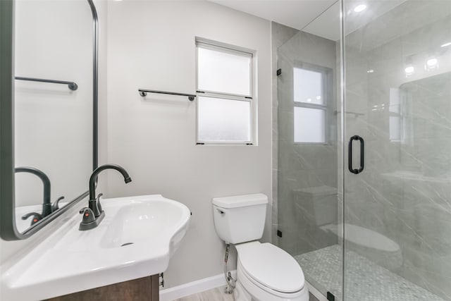 bathroom featuring walk in shower, vanity, and toilet