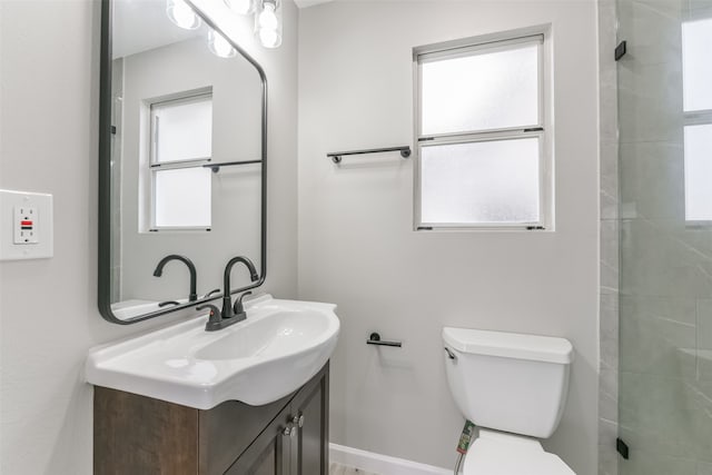 bathroom featuring vanity, toilet, and tiled shower