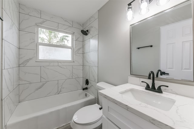 full bathroom featuring vanity, tiled shower / bath combo, and toilet