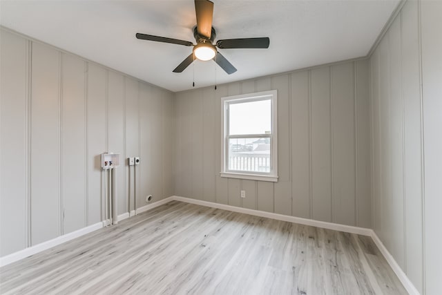 empty room with light hardwood / wood-style flooring and ceiling fan