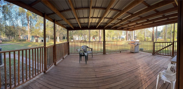 deck featuring area for grilling, a shed, and a yard