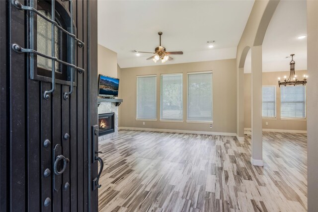 16979 Concord Dr, Conroe, TX 77385 - foyer entrance featuring arched walkways, a ceiling fan, wood finished floors, and baseboards