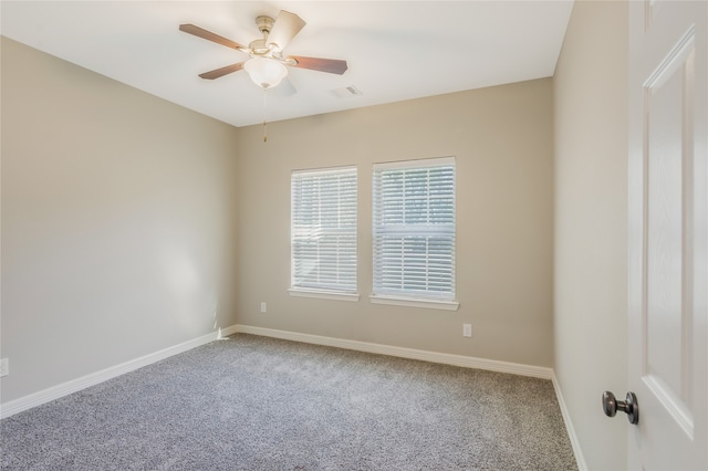 carpeted spare room featuring ceiling fan