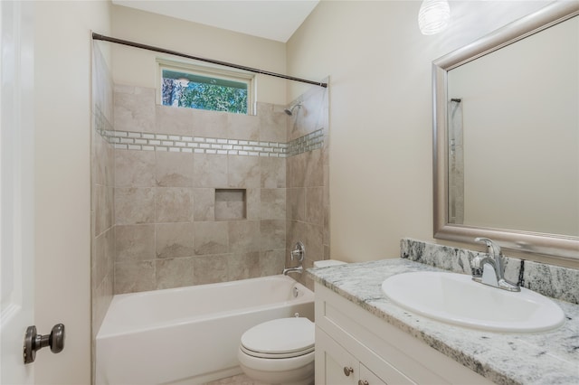 full bathroom with vanity, toilet, and tiled shower / bath