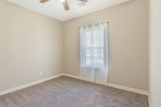 empty room with ceiling fan and carpet