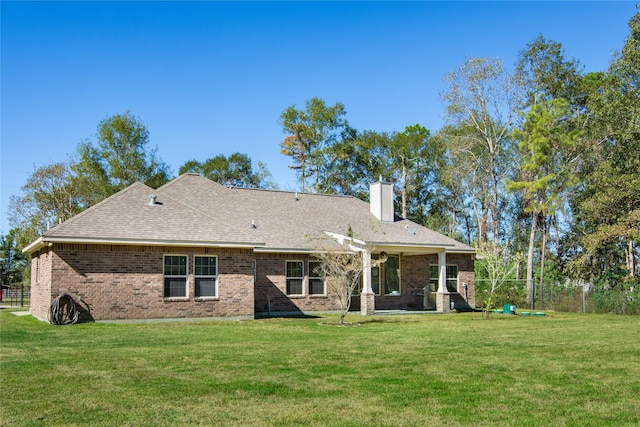 16979 Concord Dr, Conroe, TX 77385 - rear view of house with a chimney, brick siding, and a shingled roof