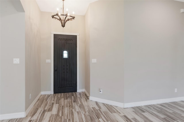 16979 Concord Dr, Conroe, TX 77385 - foyer entrance featuring light wood-style flooring, a chandelier, and baseboards