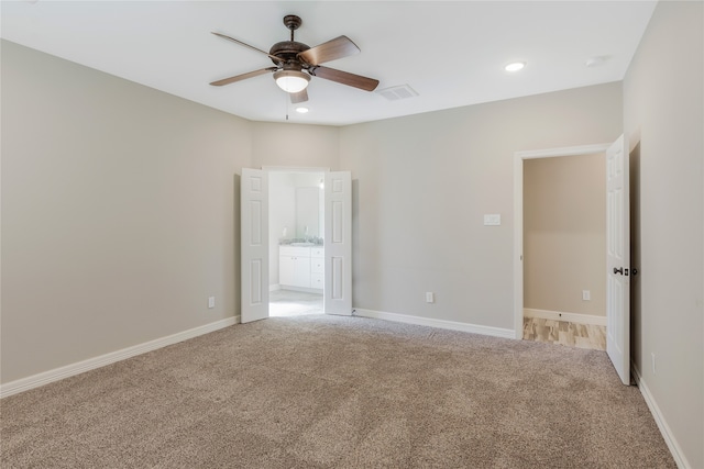 empty room featuring light colored carpet and ceiling fan