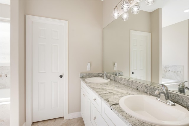 16979 Concord Dr, Conroe, TX 77385 - bathroom with double vanity, a bath, a chandelier, baseboards, and tile patterned flooring