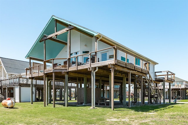 rear view of house with a deck and a lawn