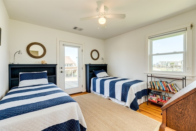 bedroom with light hardwood / wood-style flooring, multiple windows, and ceiling fan