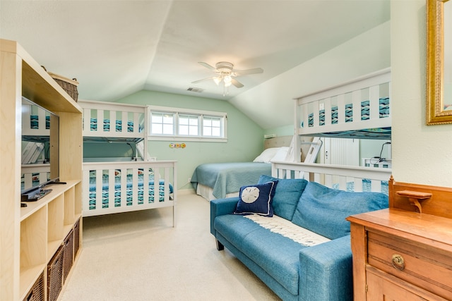 carpeted bedroom with ceiling fan and vaulted ceiling