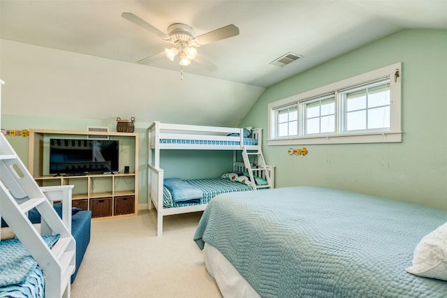 bedroom with ceiling fan, lofted ceiling, and light carpet