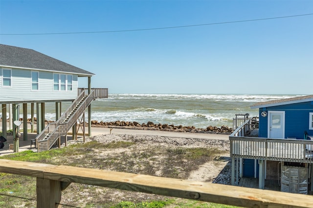 exterior space with a water view and a view of the beach