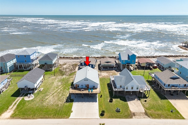 birds eye view of property with a water view and a view of the beach