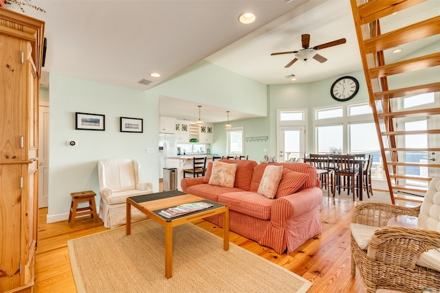 living room featuring ceiling fan and light hardwood / wood-style floors