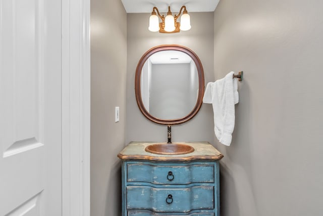 bathroom with vanity and an inviting chandelier