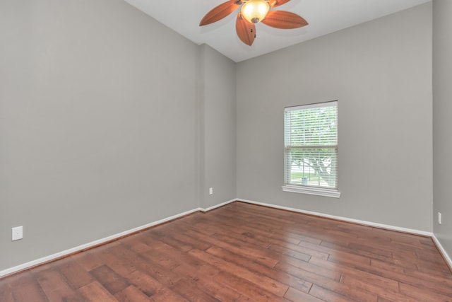 empty room with ceiling fan and dark wood-type flooring