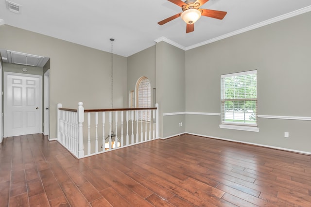 empty room with dark hardwood / wood-style flooring, ceiling fan, and ornamental molding