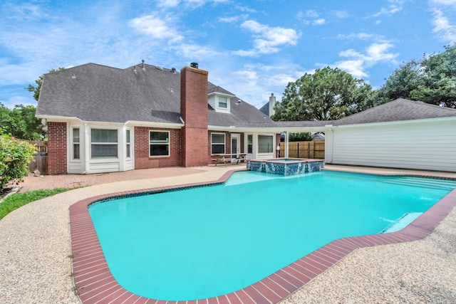 view of pool with a patio area and an in ground hot tub