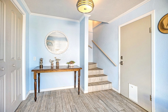 entryway featuring ornamental molding and light wood-type flooring