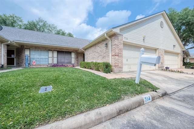 single story home with a garage and a front lawn