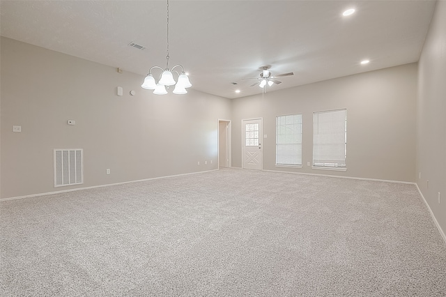 spare room featuring ceiling fan with notable chandelier and carpet floors