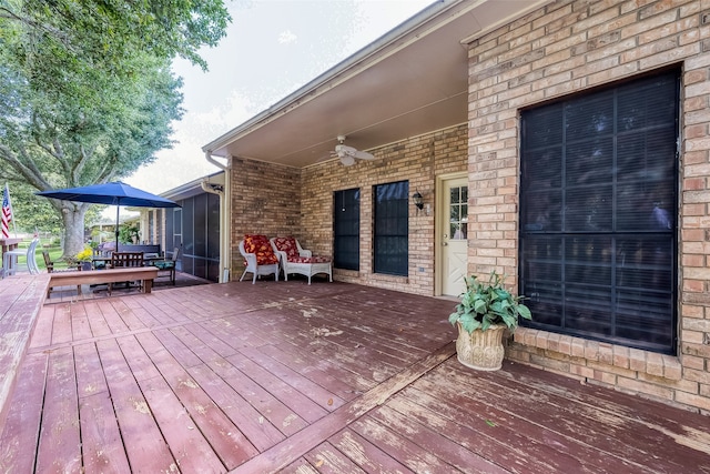 deck featuring a sunroom and ceiling fan