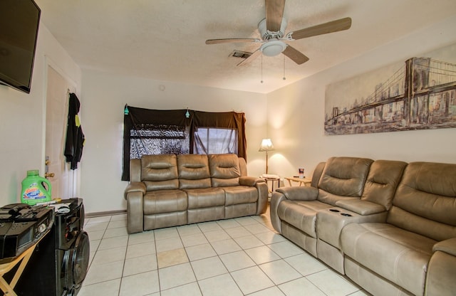 tiled living room featuring ceiling fan and a textured ceiling