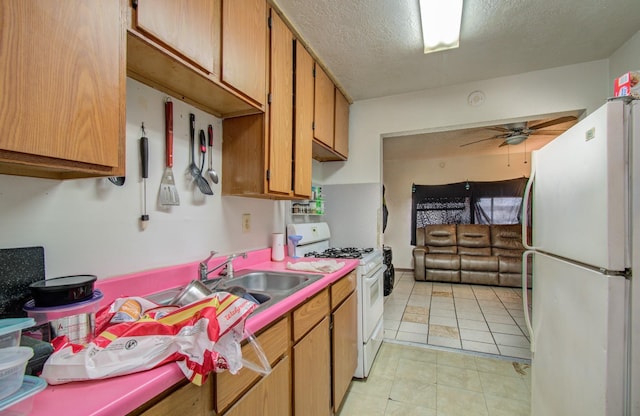 kitchen with ceiling fan, white appliances, a textured ceiling, and light tile patterned floors