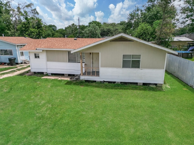 rear view of property with a lawn