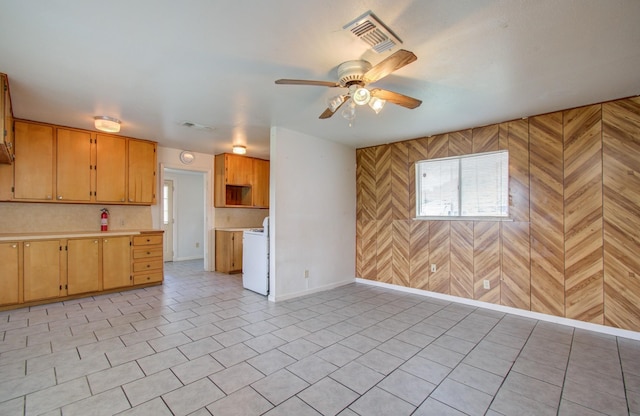 kitchen featuring white range oven, wood walls, and ceiling fan